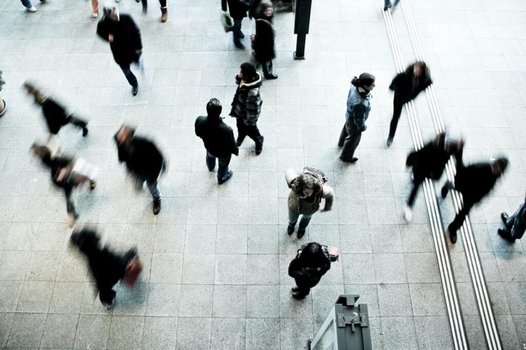 Blurred image of people walking in public place to represent demographics