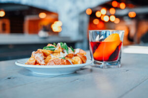Photograph of an entree and cocktail at the Iberian Rooster in St. Petersburg, Florida