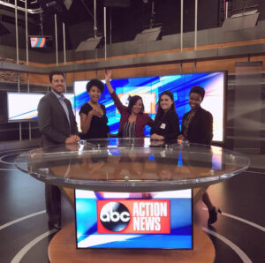 Evolve & Co team standing behind the ABC Action News Tampa, Florida news desk