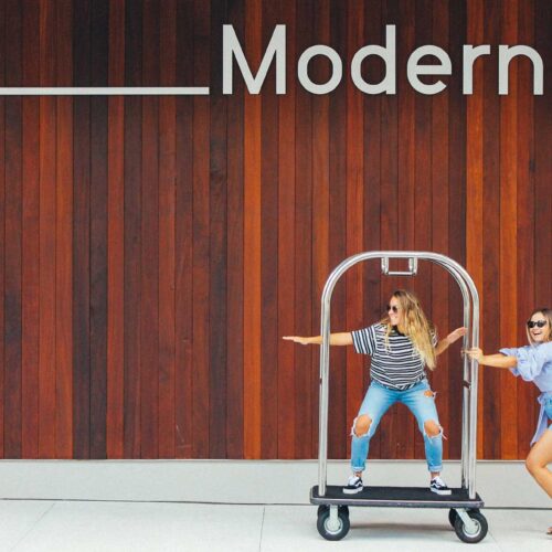 Women on luggage cart at The Sarasota Modern