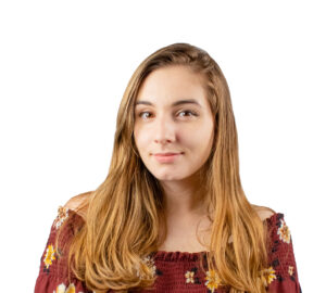 Eleni Kashis sitting for a headshot in a red top for Evolve & Co